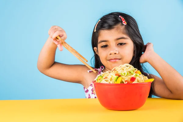 Gelukkig Aziatische kind eten heerlijke noodle, klein Indiaas meisje noedels eten in rode kom — Stockfoto