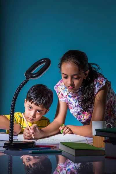 Cute indian kids studying, smart asian girl and boy doing home work, indian siblings studying, indian small girl helping her brother in doing homework — Stock Photo, Image