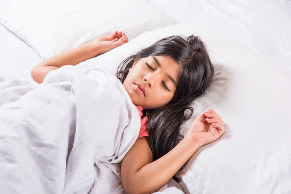cute Indian Girl sleeping over white pillow, small asian girl sleeping on bed