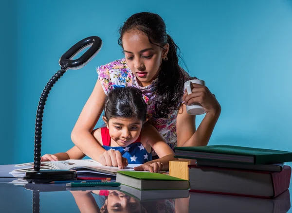 cute indian girls studying, smart asian girls doing home work, indian siblings studying, indian small girls doing homework together