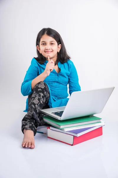 Cute little indian girl studying on laptop, asian small girl studying and using laptop, innocent indian girl child and study concept with pile of books & laptop — Stock Photo, Image