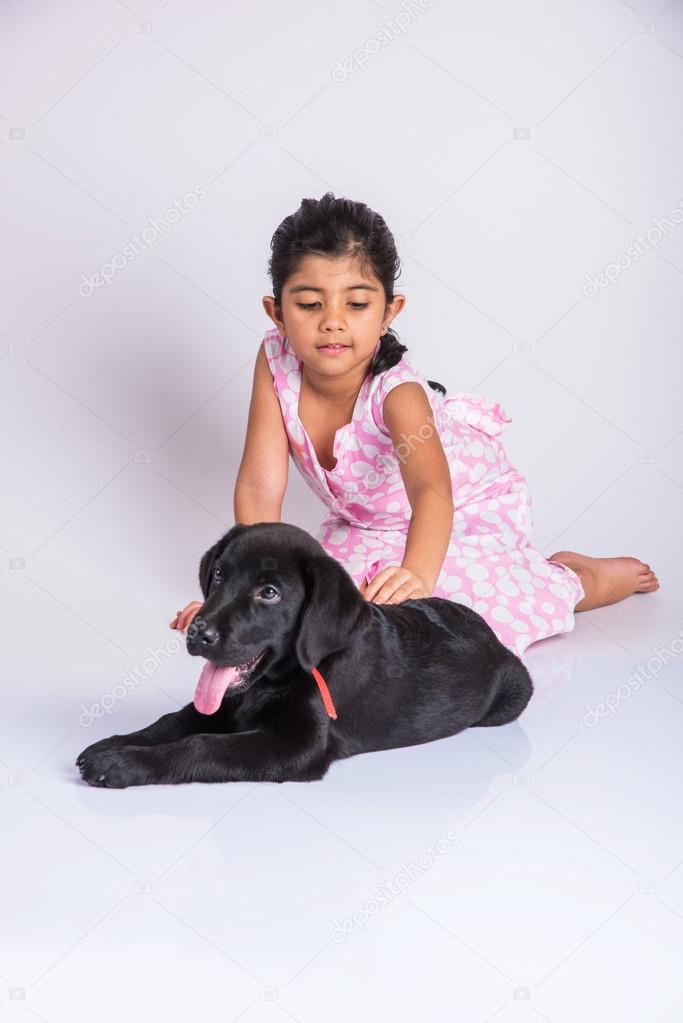 Indian girl and black labrador puppy, asian girl with dog Stock Photo by © 115432584 Indian girl and black labrador puppy, asian girl with dog Stock Photo by © 115432584