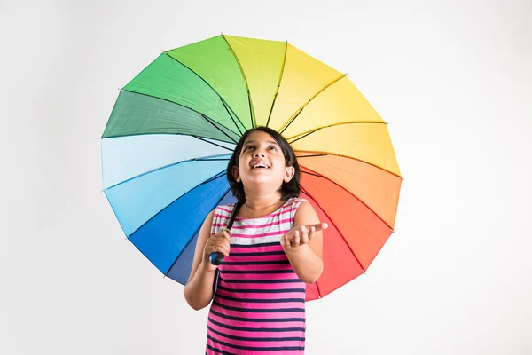 Indian small girl with multicolored umbrella, isolated over white — Stock Photo, Image