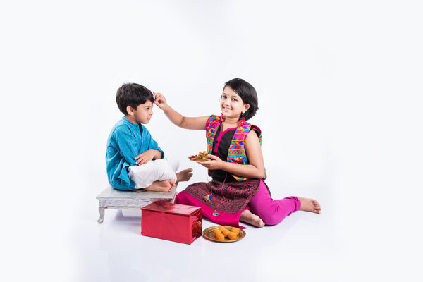 Indian small brother and sister enjoying and celebrating Raksha Bandhan festival Royalty Free Stock Images