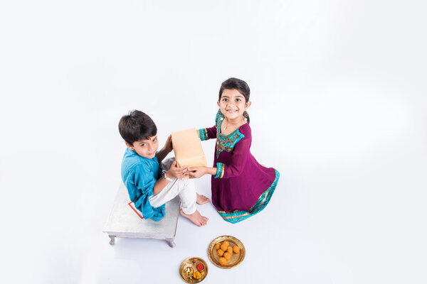 Indian small brother and sister enjoying and celebrating Raksha Bandhan festival Stock Picture
