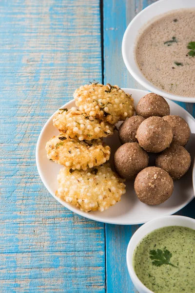 Preview Save to a lightbox  Find Similar Images  Share Stock Photo: indian fasting recipes, navratri vrat food, mahashivratri food, ekadashi food recipe, upwas food, sabudana khichadi from soaked Sabudana or sago, groundnut sweet laddu, sabudana vad