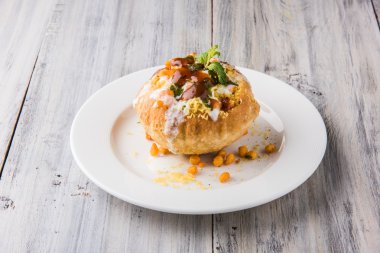 Rajasthani Shahi Raj Kachori, stuffed katchori with potato and sprout filling and served with curd, chutney and sev clipart