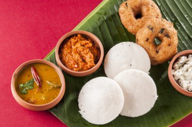 food South Indian food idli vada with sambar on a banana leaf clipart