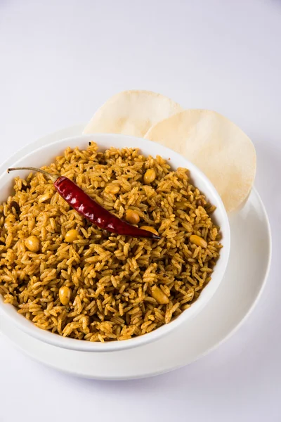 Tamarind Rice or puliyodharai rice and Poppadom from Tamil Nadu, India