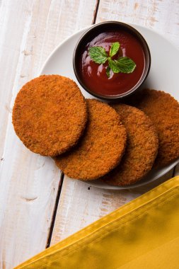 Hint sohbet madde aloo veya aalu tikki veya tikiya veya ragda köftesi ile domates ketçap, seçici odak hizmet olarak da bilinen kızarmış patates kek