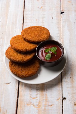 Hint sohbet madde aloo veya aalu tikki veya tikiya veya ragda köftesi ile domates ketçap, seçici odak hizmet olarak da bilinen kızarmış patates kek
