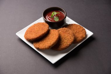 Hint sohbet madde aloo veya aalu tikki veya tikiya veya ragda köftesi ile domates ketçap, seçici odak hizmet olarak da bilinen kızarmış patates kek