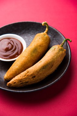 Indian stuffed green chilli pakora or mirch pakode or mirch pakora or pakoda or mirchi bhaji in marathi clipart
