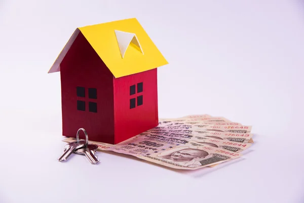 Comprar casa en préstamo o concepto de alquiler utilizando casa modelo, calculadora, billetes de moneda india, bolígrafo y gafas —  Fotos de Stock