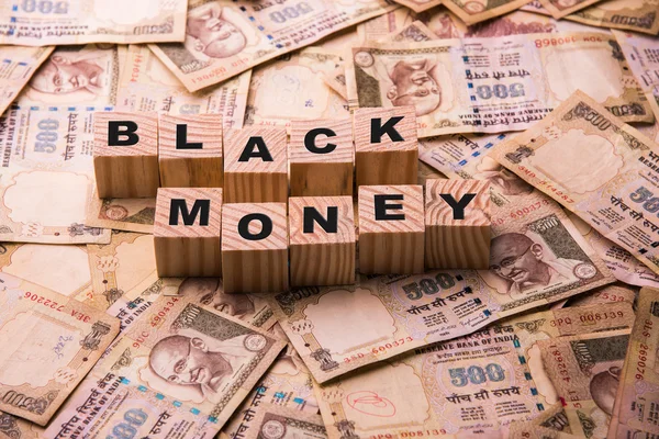 Indian currency 500 rupee notes lying on ground with Black Money written using wooden blocks — Stock Photo, Image