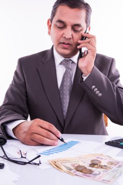Hint adam veya muhasebeci kişi dosyalama Hint gelir vergisi beyannamesi formu veya Itr belge hint para birimi, ev modeli, oyuncak araba ve beyaz masa üstü üzerinde hesap makinesi gösteren, seçici odak
