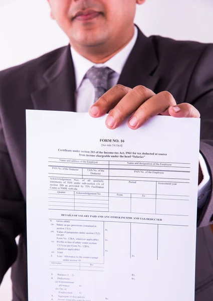 indian businessman showing indian income tax return form or ITR-4 form or form no. 16 of income tax department of india, selective focus