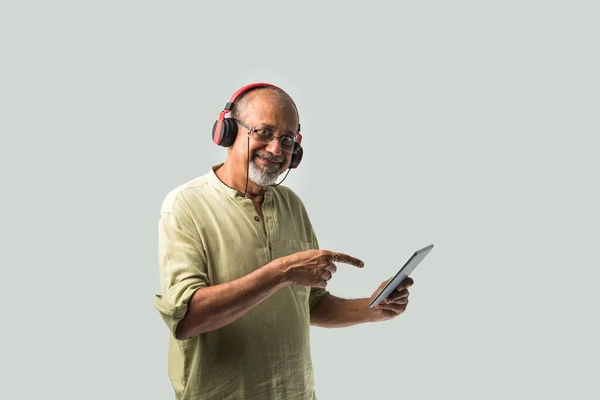 Happy Senior Indian Asian Bearded Man Smiling Using Headphones Smartphone — Stock Photo, Image