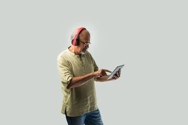 Happy Senior Indian Asian Bearded Man Smiling Using Headphones Smartphone — Stock Photo, Image