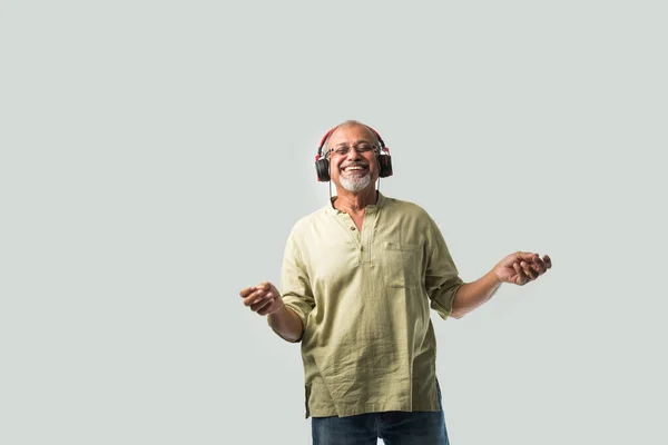 Happy Senior Indian Asian Bearded Man Smiling Using Headphones Smartphone — Stock Photo, Image