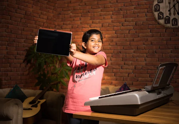 Asian Indian Child Learning Music Musical Instrument Online Using Laptop — Stock Photo, Image