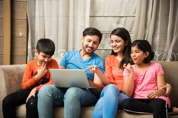 Indian Family Sitting Sofa Using Smartphone Laptop Tablet Watching Movie — Stock Photo, Image