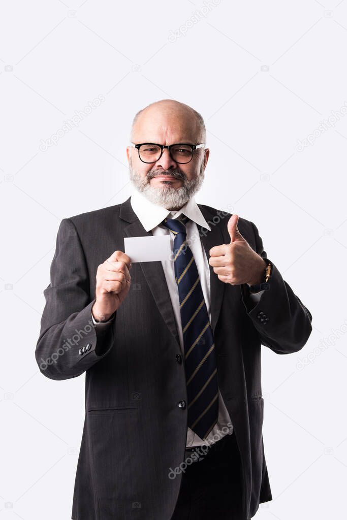 Portrait of happy Indian asian senior businessman holding blank Identity or credit or debit card