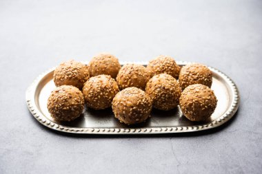 Susam tohumu jaggery topu ya da ke laddo ve tilgul ya da gul laddu Hindistan 'daki Makar Sankranti Festivali için kasede servis yaparlar.