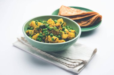 Aloo Mutter veya Matar aalu dry sabzi, Hint Patatesi ve yeşil bezelyeler baharatla kızartılmış ve kişniş yapraklarıyla süslenmiş. Roti veya chapati ile servis edilir.