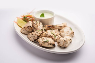 Hint Afgan tavuğu Malai Tikka taze salatayla servis edilen ızgara Murgh kremalı kebaptır.