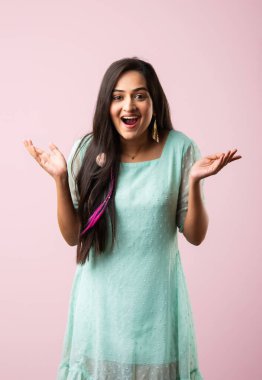 Hintli güzel kız ya da genç kadının üzerine pembe arka planda parıltı düşüyor.