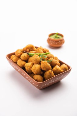 Muson Özel Moong Dal Vada, Pakoda, Dalwada, Pakora veya Mungdal Bhajiya veya Yeşil Chutney ile servis edilen Sarı Börek. seçici odak