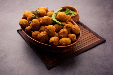 Muson Özel Moong Dal Vada, Pakoda, Dalwada, Pakora veya Mungdal Bhajiya veya Yeşil Chutney ile servis edilen Sarı Börek. seçici odak