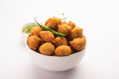 Muson Özel Moong Dal Vada, Pakoda, Dalwada, Pakora veya Mungdal Bhajiya veya Yeşil Chutney ile servis edilen Sarı Börek. seçici odak