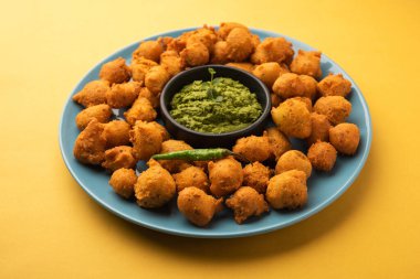 Muson Özel Moong Dal Vada, Pakoda, Dalwada, Pakora veya Mungdal Bhajiya veya Yeşil Chutney ile servis edilen Sarı Börek. seçici odak