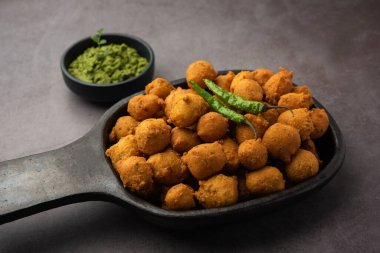 Muson Özel Moong Dal Vada, Pakoda, Dalwada, Pakora veya Mungdal Bhajiya veya Yeşil Chutney ile servis edilen Sarı Börek. seçici odak