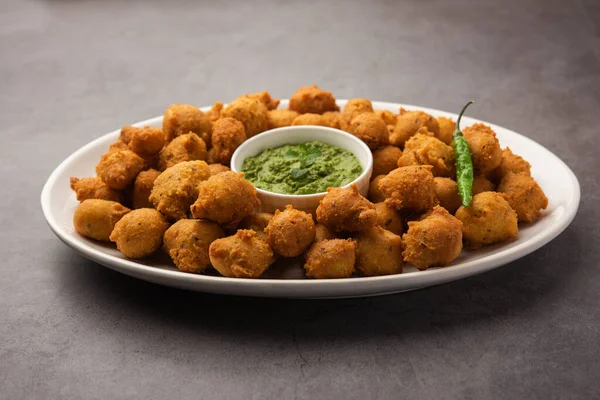 Muson Özel Moong Dal Vada, Pakoda, Dalwada, Pakora veya Mungdal Bhajiya veya Yeşil Chutney ile servis edilen Sarı Börek. seçici odak