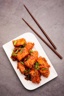 Çıtır biberli paneer, tatlı ekşi ve baharatlı acı biber soslu kızarmış süzme peynirin bir tabakta servis edilerek yapılan bir Hint Çin aperatifi. seçici odak