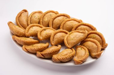 Gujiya veya gujia veya karanji - Holi ve diwali festivali sırasında yapılan tatlı hamur tatlısı, bir tabakta servis edilir. seçici odak