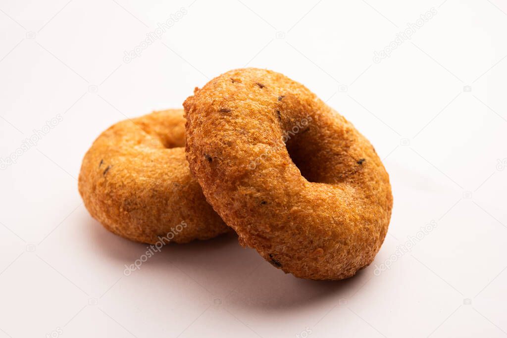 South Indian Vada, Medu vada or dal vadai in plate or bowl, isolated on plain background, selective focus