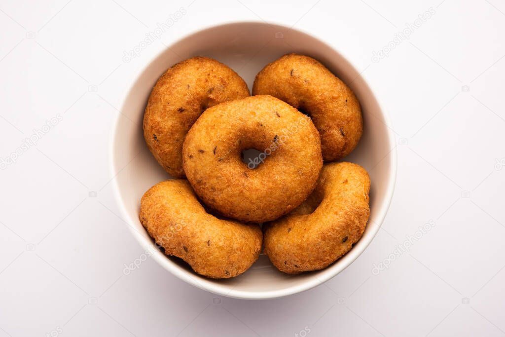 South Indian Vada, Medu vada or dal vadai in plate or bowl, isolated on plain background, selective focus