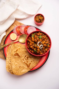 Tikona Paratha or Triangle parotha with chole or choley or chana masala clipart