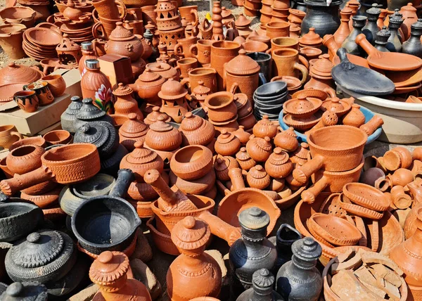 Indian traditional terracotta or red clay pottery or earthenware kept on display in roadside shop in village