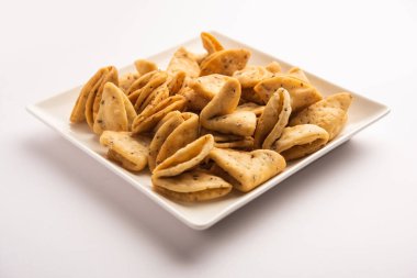 Layered or strips Mathri or mathiya is a popular snack recipe that people enjoy with tea in Northern India clipart