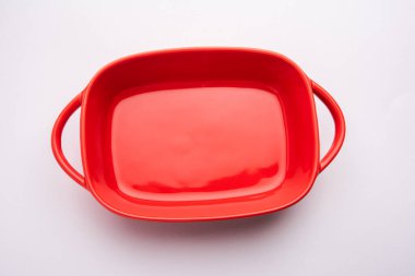 Empty red ceramic serving bowl, isolated over white or gray background