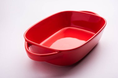 Empty red ceramic serving bowl, isolated over white or gray background