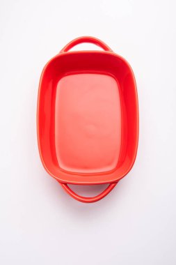 Empty red ceramic serving bowl, isolated over white or gray background