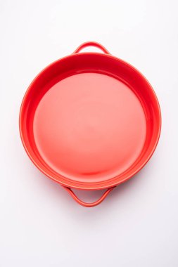 Empty red ceramic serving bowl, isolated over white or gray background