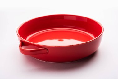 Empty red ceramic serving bowl, isolated over white or gray background