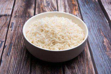 Aromatic Long Basmati cooked plain Rice is an Indian main course food, served in a bowl. selective focus